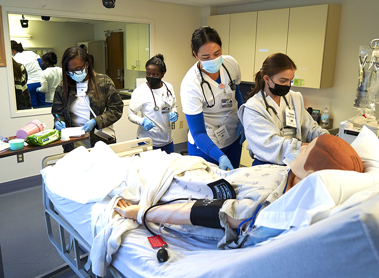 student group inside a star center simulation suite working to diagnos the simulation patient
