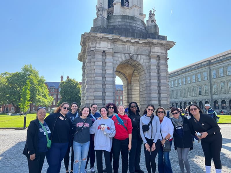 Faculty, staff, students and alum from the McAuley School of Nursing and the College of Health Professions at UDM pose on the campus of Trinity College Dublin