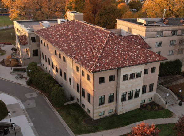 The Health Professions Facility at sunset, seen from a high-angle drone, with autumn trees