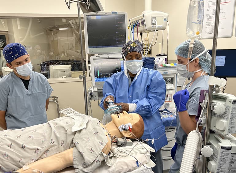 student performing an intubation on a sim-manikin