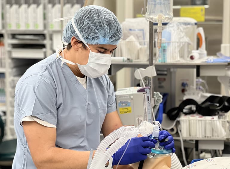 male crna intubating a sim manikin