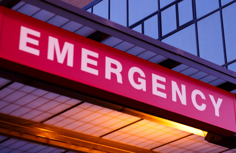 Emergency room sign on hospital building..