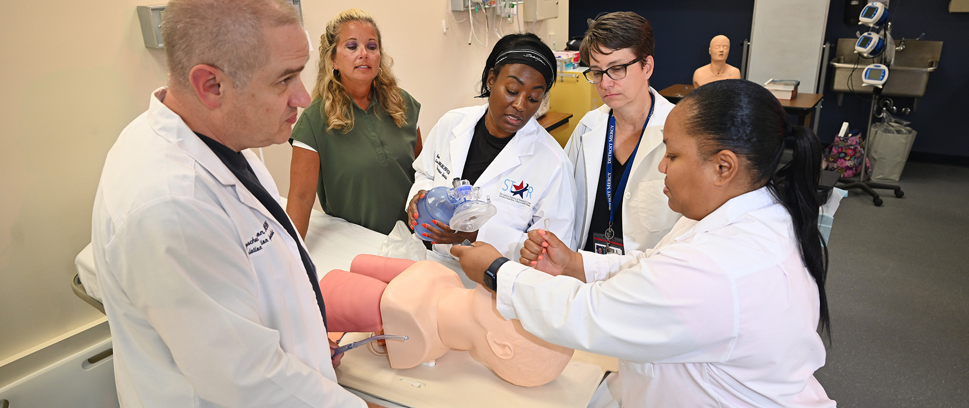 Students work together on a manikin 