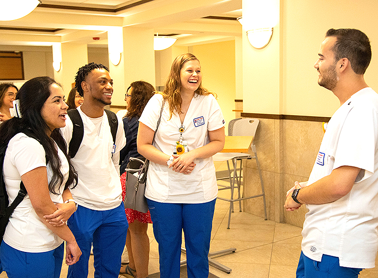 nursing students in a group joking with one another