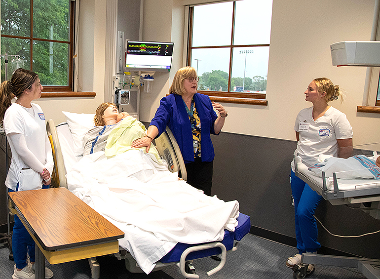 prof in obstetrics sim-suite with two BSN students