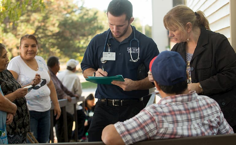 nursing student on Aquinas campus getting patient info