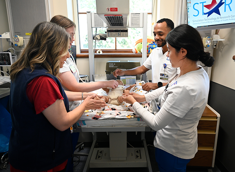 pediatric sim lab with students and prof