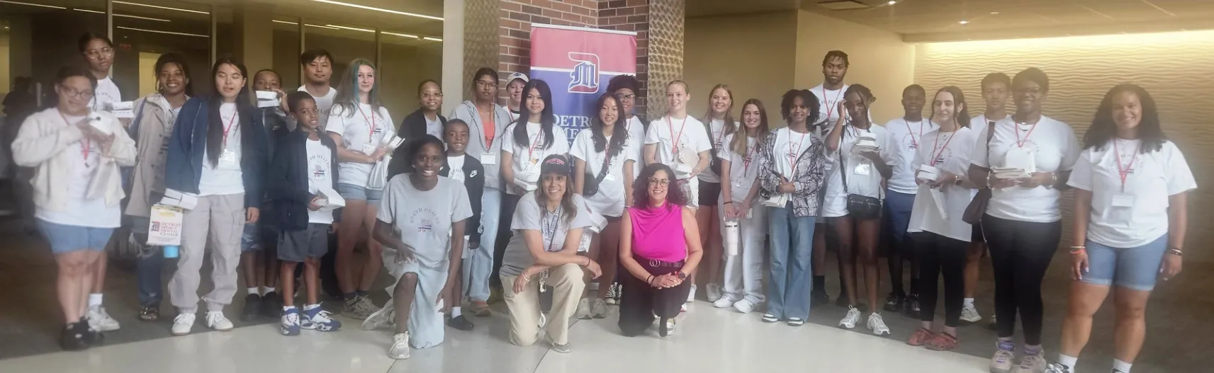 Large group of campers with camp coordinators on McNichols Campus
