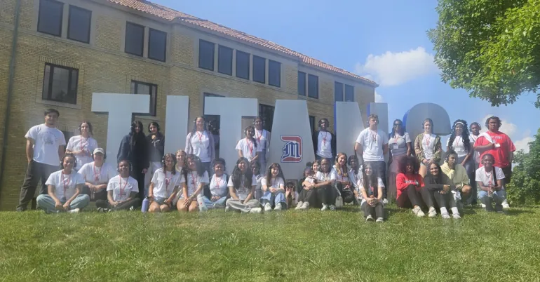 Youth Health campers surrounding the TITANS sign on McNichols Campus