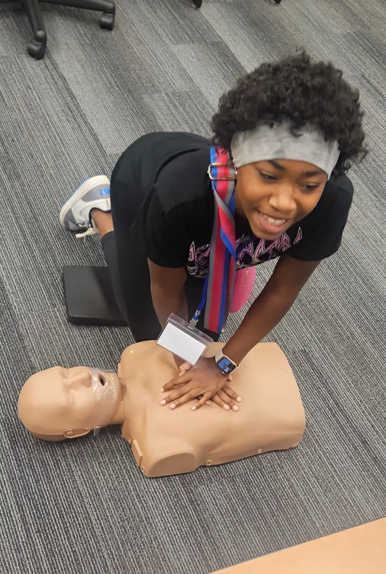 Youth Health Camper practicing CPR